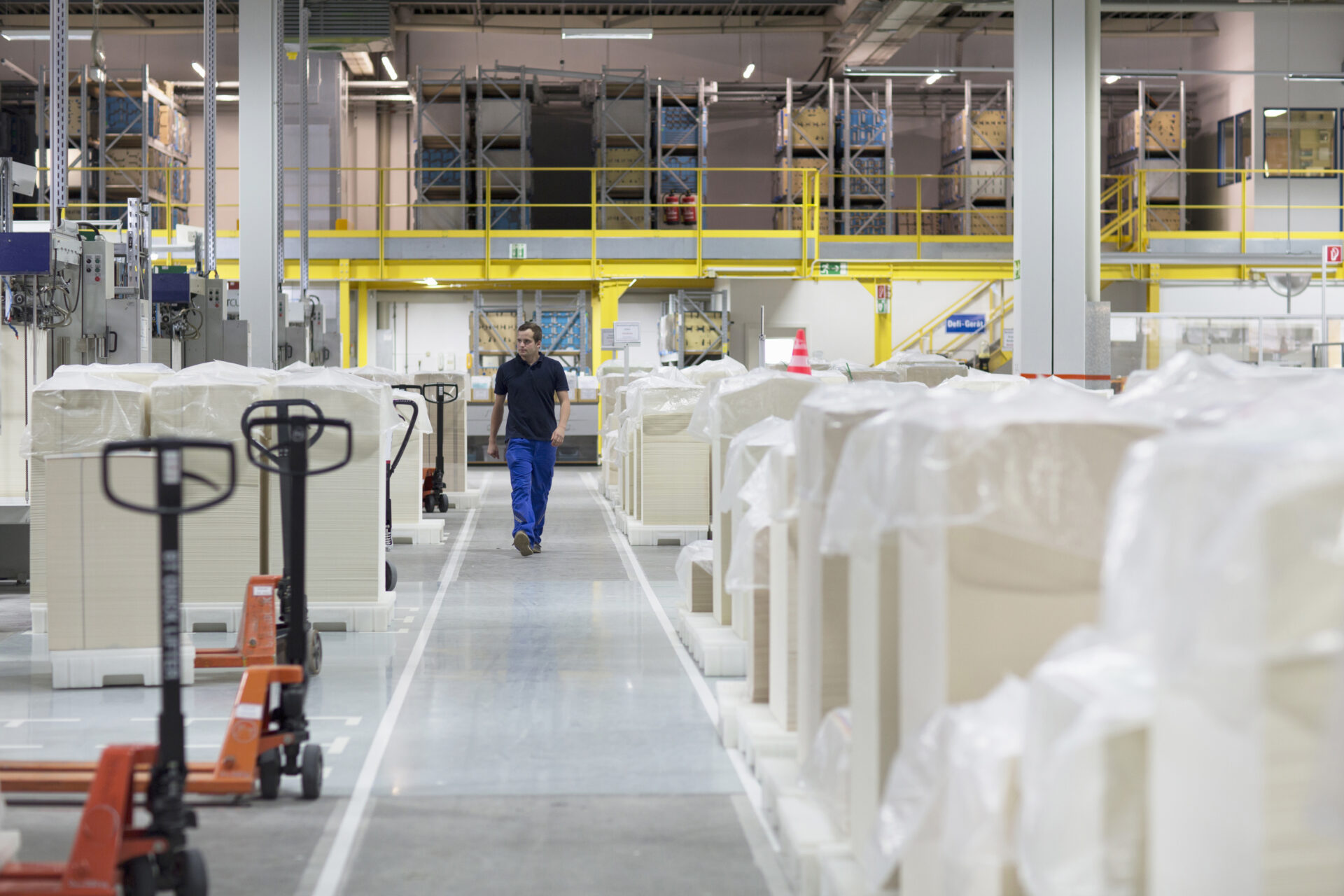 worker-walking-through-paper-packaging-factory